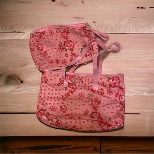 Woman within set of two vinyl, tote bags, pink floral Zip closure